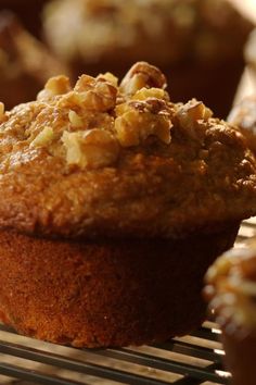 muffins cooling on a wire rack with walnuts in the top and bottom