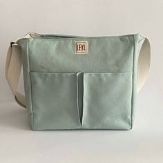 "Handmade cotton canvas tote bag with zipper that I specially designed for everyday use. Check out my tote bags for the very best in unique or custom, handmade from women's bags shop. If you want to see a different style, take a look at my collection ⬇ https://etsy.me/3fgNzR9 🎁 WHAT IS IN THE PACKAGE * 1 piece Large tote bag with zipper closure Usage: Shoulder Bag and Crossbody Bag Gender: Unisex In summary; Total pockets: 9 pockets and 2 pen holders BODY *  Cotton Canvas. The fabric has stain-proof and water-repellent properties with OEKO-TEX Standard 100 certified. (It is not completely waterproof, however.) *  Zip closure and cover * BODY FRONT:  2 pockets * BODY BACK:  1 large pocket * Fixed and adjustable canvas strap INTERIOR  *  100% cotton lining *  SIDE: 2 small pocket *  INTERIO Tote Bag With Compartments, Bag With Compartments, Planner Pouch, Tote Bag With Zipper, Teacher Tote Bag, Teacher Tote, Fabric Tote Bags, Bag With Zipper, Crossbody Tote Bag