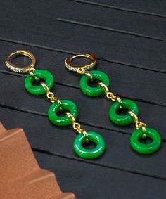 Indulge in timeless sophistication with our Vintage Green Jade Circle Drop Earrings. Crafted with sterling silver and overgilding, these earrings feature a beautiful jade circle design that exudes elegance and luxury. Elevate any outfit with these unique and exquisite earrings. Measurement: 7.5cm/2.925" * 1.5cm/0.585". Matches easily with daily hairstyle. dresses & Shirts Green Round Gold-plated Earrings, Green Gold Plated Round Earrings, Green Gold-plated Round Earrings, Elegant Jade Hoop Earrings, Elegant Green Circular Earrings, Enamel Stud Earrings, Daily Hairstyles, Star Studs, Dress Jewelry