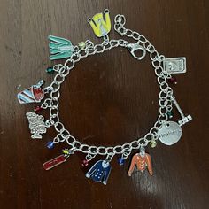 a close up of a charm bracelet on a table