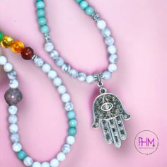 Welcome the Hamsa Chakra Healing Mala into your life! Be blessed with protection and equipped for healing with this beautiful 108 mala bead. With seven chakra stones and Amazonite, Howlite, and Turquoise accent stones all made of crystal, your spiritual security is guaranteed! The addition of Amethyst makes this piece especially powerful, - purifying your aura by removing any negative energy or feelings while grounding you in its powerful calming energy.But it doesn't stop there! This incredible Spiritual Amazonite 8mm Beads Jewelry, Spiritual Amazonite Jewelry With 8mm Beads, Spiritual Silver Mala With 8mm Beads, Silver Beaded Necklace For Meditation With 8mm Beads, Holistic Crystal Necklaces With 8mm Beads For Meditation, Holistic Crystal Necklace With 8mm Beads For Meditation, Holistic Crystal Necklace For Meditation With 8mm Beads, Spiritual Round Bead Jewelry For Yoga, Spiritual Mala With 8mm Beads For Healing