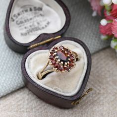 A beautiful Mid-Century vintage 9ct gold and garnet floral cluster ring. A wonderful, quality piece of vintage fine jewellery. Stamped with UK hallmarks for 9ct gold to the inside, 1976. In really nice vintage condition. Please be sure to see all of the photos. - UK Size - O - US Size - 7 1/4 - Weight - 1.9 grams -------------------- All boxes in the photographs are for display purposes only, unless otherwise stated. Please be aware there will be marks and wear commensurate with age. Please see Vintage Garnet Birthstone Rings, Vintage Garnet Cluster Ring As Gift, Vintage Gold Ruby Cluster Ring, Vintage Gold Cluster Ruby Ring, Antique Cluster Ring As A Gift, Vintage Cluster Ring Suitable For Gifts, Vintage Garnet Cluster Ring With Gemstone, Vintage Yellow Gold Cluster Ring With Birthstone, Vintage Garnet Cluster Ring For Anniversary