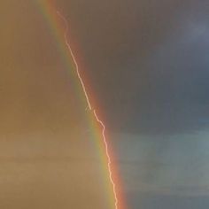 there is a rainbow in the sky and it appears to be lightning