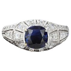 Understated elegance in an exceptional package. This charming ring is centered with a cushion cut sapphire that weighs approximately 0.90ct and has 44 round cut diamonds that weigh approximately 0.50ct. The setting has a raised dome effect with milgrain beading. The color of these diamonds is H with VS clarity. The ring weighs 4 grams. Size 7 Sapphire And Diamond Ring, Ring Art Deco, Detailed Ring, Sapphire Diamond Ring, Dream Jewelry, Sapphire Diamond, Round Cut Diamond, Cushion Cut, Cocktail Rings