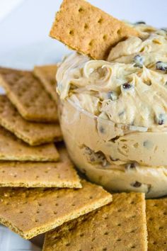 crackers and dip in a bowl on a plate