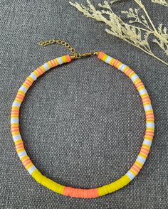 This necklace is handmade to last, with a nice colorful pattern, perfect for the summer (or any time of the year, really)! This choker necklace gives bohemian-style vibes to your look. Each boho-style necklace was created with 6 mm clay polymer discs, stainless steel-look lobster clasp, and 2 inch extender chain. I'm offering this necklace in seven different lengths. If you are interested in a different length or colors, please message me! My business thrives on Customer Satisfaction Please do not hesitate to reach me in case there is something wrong with your purchase. I will try my best to make it right for you. Thank you for shopping JGBestBeadedJewelry! Handmade Yellow Necklaces For Vacation, Handmade Yellow Necklace For Vacation, Handmade Orange Heishi Beads Jewelry, Yellow Letter Beads Jewelry For Festival, Casual Orange Beaded Necklaces For Gifts, Casual Orange Necklaces For The Beach, Orange Beaded Necklaces With Letter Beads For Beach, Orange Letter Beads Necklace For Beach, Handmade Yellow Heishi Beads Jewelry