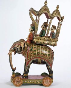 an elephant with people riding on it's back