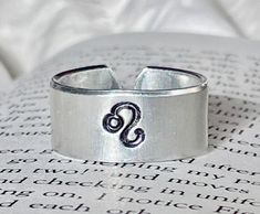 "3/8\"W Aluminum - great quality! Note - Please choose your Zodiac sign and Ring size (4 - 11 1/2) before proceeding to checkout. If you would like to personalize the ring on the inside please add under personalization. This ring is adjustable in size. Super in style!" Adjustable Symbolic Personalized Rings, Personalized Adjustable Symbolic Rings, Adjustable Personalized Symbolic Rings, Adjustable Symbolic Hand Stamped Jewelry, Adjustable Hand Stamped Symbolic Jewelry, Adjustable Symbolic Hypoallergenic Rings, Rings Hand, Hand Stamped Metal, Zodiac Rings