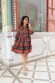 Discover the charm of traditional Indian craftsmanship with our exquisite Kalamkari Jaipuri print knee-length dress. Handcrafted from soft Indian cotton, this dress features a captivating blend of vibrant black and rich red hues in intricate Jaipuri patterns. Perfect for both casual and festive occasions, it offers comfort, style, and a touch of cultural elegance. Elevate your wardrobe with this unique piece that celebrates India's rich textile heritage Model is wearing size S and is 5'feet 4 in Jaipuri Dress, Kalamkari Kurtis, Traditional Dress With Kalamkari Print For Festivals, Long Sleeve Dresses With Motifs For Navratri, Traditional Straight Kurta Dress With Block Print, Bohemian Dresses With Motifs For Navratri, Festive Kalamkari Print Dress With Long Sleeves, Festival Straight Kurta Dress With Motifs, Multicolor Kalamkari Print Straight Kurta Dress