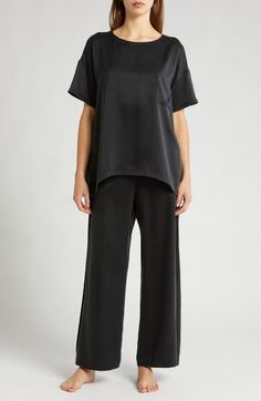 These mulberry-silk pajamas are naturally hypoallergenic, breathable and ideal for those with sensitive skin; best part—they can go in the washing machine. The elegant set pairs an oversized high-low T-shirt with flowy pants enhanced with split cuffs and side-seam pockets. Top has 28" front length, 30 1/2" back length; bottoms have 29" inseam, 25" leg opening, 12 1/2" front rise, 16 1/2" back rise (size Medium) Top has scoop neck; short sleeves; chest patch pocket; high/low hem Pants have back e Silk Tops With Relaxed Fit For Loungewear, Elegant Silk Sleepwear For Relaxation, Silk Sleepwear For Loungewear In Relaxed Fit, Silk Sleepwear Relaxed Fit For Loungewear, Chic Silk Loungewear Sets, Chic Short Sleeve Sleepwear For Loungewear, Elegant Silk Sleepwear With Relaxed Fit, Elegant Silk Sleep Tops, Elegant Silk Nightwear Tops