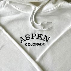 Hooded Tops With Letter Embroidery For Streetwear, Embroidered Hoodie For Spring Streetwear, Embroidered Hoodie For Streetwear In Spring, Spring Embroidered Hoodie For Streetwear, Streetwear Long Sleeve Hoodie With Letter Embroidery, Long Sleeve Hoodie With Letter Embroidery For Streetwear, Spring Hooded Top With Embroidered Logo, White Cotton Hoodie With Embroidered Logo, Varsity Cotton Hoodie With Embroidered Logo