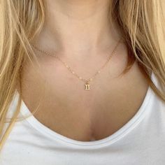 Elevate your style and showcase your astrological sign with our Gemini Zodiac Symbol 14K Gold Necklace. Handcrafted with a 14K gold filled chain and a 18k vermeil gold charm, this minimalist yet meaningful necklace is the perfect addition to your jewelry collection. Available in 16 or 18 inch necklace sizes. Celebrate yourself or a loved one with fine jewelry that shines as bright as your special day! 14k gold chain 14k lobster clasp 18k vermeil gold charm 16 & 18 necklace sizes makes a great gi Gold Minimalist Zodiac Charm Necklace, Minimalist Gold Zodiac Sign Necklace, Gold Dainty Zodiac Sign Charm Necklace, Dainty Zodiac Sign Necklace For Gift, Dainty Zodiac Sign Pendant Necklace, Gemini Zodiac Symbol, Gemini Necklace, Gemini Pendant, Meaningful Necklace