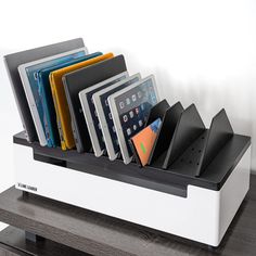 a white and black shelf holding several different types of folders