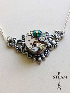 This is one of our newest creations, available with different Swarovski crystals: pick your favorite color! This steampunk necklace features a real watch mechanism to give an industrial look to this refined victorian inspired setting. The link chain is 925 Sterling Silver. This fantastic necklace will be gift boxed . We offer FREE shipping on the second any any subsequent items when you shop with us All you need to do is add the item to your Shopping Cart and pay with Etsy's checkout system and Steampunk Silver Metal Necklaces, Silver Steampunk Metal Necklace, Steampunk Silver-color Brass Necklaces, Steampunk Silver Brass Necklaces, Silver Steampunk Brass Necklaces, Steampunk Jewelry With Vintage Charm, Steampunk Silver Pendant Necklace, Silver Steampunk Pendant Necklace, Steampunk Silver Round Pendant Jewelry