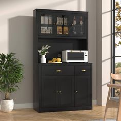 a black cabinet with a microwave on top and some plants in the corner next to it