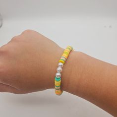 a person's arm with a bracelet on it