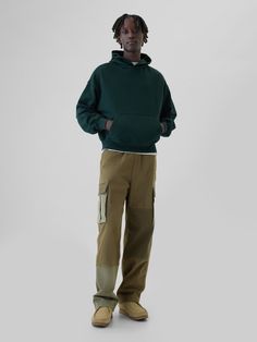 Soft, stretch cotton twill cargo pants.  Elasticized waist with drawcords.  Front slant pockets, back welt pockets.  Side cargo pockets.  Ties at hem for cinching.  Allover patchwork detailing.  This pant is made with 98% regenerative cotton, which is grown using holistic agricultural practices that improve soil health, climate resilience, water retention, and local biodiversity.  This product was made in a factory that invests in gender equality and women’s empowerment.  Through RISE Reimaginin Sporty Gap Sweatpants For Streetwear, Cotton Utility Sweatpants With Patch Pockets, Utility Cotton Sweatpants With Patch Pockets, Utility Sweatpants With Hip Pockets, Sporty Gap Bottoms With Side Pockets, Green Utility Parachute Pants With Cargo Pockets, Green Relaxed Fit Cargo Pants With Patch Pockets, Urban Green Cargo Jeans With Hip Pockets, Green Parachute Pants For Fall Streetwear