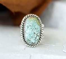 Handcrafted Blue Moon Web Turquoise Statement Cocktail Ring - Boho Chic Jewelry. This chunky ring has been handmade using scrap 925 Sterling Silver that has been fused, patina-ed then polished. The setting is an oval 22mm x 13mm Blue Moon Web Turquoise cabochon that is in a Bezel setting accented with twisted wire. The tapered wide band is 1/2" then narrows to 1/4" for a comfortable fit. This ring cannot be resized. Size 7 Add a touch of celestial allure to your ensemble with this cool, 100% Nat Handmade Adjustable Oval Turquoise Ring, Rustic Sterling Silver Turquoise Ring Gift, Rustic Silver Turquoise Ring For Gift, Rustic Silver Turquoise Ring Gift, Rustic Untreated Rings For Gift, Rustic Untreated Ring As A Gift, Rustic Untreated Ring For Gift, Handmade Adjustable Turquoise Ring For Anniversary, Handmade Rustic Silver Turquoise Ring