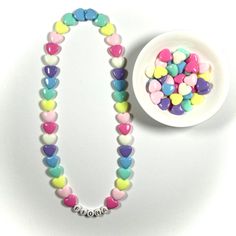 "You have just found the perfect gift for birthdays or Easter! This cute pastel, retro HEART necklace can come personalized or with hearts only. This 16\" stretchy necklace fits right over your head so it's easy to put on- no clasps needed. The matching bracelet is listed here: https://www.etsy.com/listing/909362079/kids-heart-bracelet-party-favor-girls?ref=shop_home_active_5&frs=1 Please check all selections and spelling prior to check out. Our custom jewelry is made to order so all sales a Bracelet Party, Retro Heart, Girls Necklace, Jewelry For Girls, Necklace Cute, Matching Bracelet, Name Jewelry, Birthday Gifts For Kids, Girls Necklaces