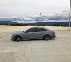 a grey car parked in an empty parking lot