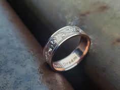 a wedding band with an intricate design on the inside is shown in this close up photo