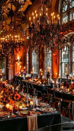 an elegant dining room with chandeliers and tables covered in black tablecloths