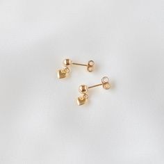 A pair of simple gold-filled earrings adorned with a tiny heart. Made of 14K gold filled materials, these earrings are tarnish-resistant, water-resistant, and hypoallergenic. Earring posts measure 4 mm in diameter while the heart measures approximately 6 x 6 mm. Gift box included with purchase. --------------------♥ PROMOS ♥-------------------- Want 10% off? Join the mailing list by visiting http://bit.ly/vedern . Just leave me a note at checkout if you have any problems applying discount codes. Dainty Adjustable Heart Earrings, Anniversary Heart Beads Dangle Earrings, Dainty Adjustable Heart-shaped Earrings, Heart Beads Drop Earrings For Anniversary, Heart Beads Drop Earrings For Gift, Heart Beads Earrings For Mother's Day Gift, Adjustable Heart Earrings, Dainty Heart Drop Earrings For Gift, Dainty Handmade Heart Earrings For Anniversary