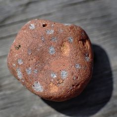 a rock sitting on top of a wooden table