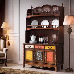 an old fashioned china cabinet with plates and glasses on it's top, in a living room