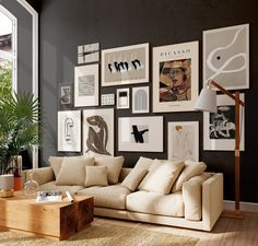 a living room filled with lots of pictures on the wall above a beige sectional couch