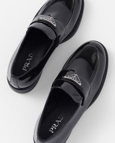 Upper with leather band Enameled metal triangle logo Rubber monoblock sole with hot-stamped logo 25 mm heel Prada Loafers Women Outfit, Prada Shoes Women, Black Prada Shoes, Loafers Aesthetic, Woman Loafers, High Heel Loafers, Prada Heels, Black Patent Leather Loafers, Prada Loafers