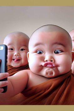 three babys with cell phones in front of them