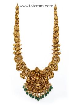 22 Karat Gold "Lakshmi - Peacock" Long Necklace with Beads & Pearls (Temple Jewellery)  Enhance Your Beauty with 22 Karat Gold "Lakshmi - Peacock" Long Necklace  This exquisite piece of temple jewelry is a symbol of elegance and tradition. Made in India by skilled artisans, this 22 Karat gold necklace is a timeless treasure that will add a touch of sophistication to any outfit. The intricate design featuring Lakshmi and peacock motifs, along with beads and pearls, exudes luxury and grace. The ne New Long Necklace Designs Gold, Long Temple Jewellery, Long Temple Jewellery Necklace, Long Chains Indian Gold Traditional, Gold Long Necklace With Grams, Gold Chain New Design, Gold Temple Jewellery Necklace Set, Gold Long Chains Indian Jewellery, Long Gold Chain Designs For Women