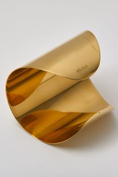 Make a bold statement with the Brass Smooth 3" Cuff Bracelet Gold—radiance and elegance in every detail. GOLD PLATED SPLENDOR: Stunning finish offers a timeless, radiant appeal. COMFORTABLE DESIGN: Wear effortlessly all day with its smooth, comfortable fit. Material Composition: Solid Brass Size: 3" Care Instructions: Bisjoux products made of solid raw brass, or silver plated brass will patina naturally over time. Dulled by age, and naturally buffed from regular touch. Your raw brass will arrive Modern Yellow Gold Cuff Bracelet For Party, Modern Gold Cuff Bracelet For Formal Occasions, Gold Modern Cuff Bracelet For Formal Occasions, Unique Brass Cuff Bracelet For Formal Occasions, Modern Gold-tone Cuff Bracelet As Gift, Modern Brass Bangle Cuff Bracelet, Modern Gold-tone Cuff Bracelet For Gift, Modern Gold-tone Cuff Bracelet Gift, Gold Cuff Bracelet Bangle