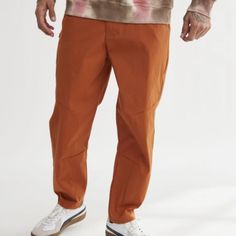 Super Nice Standard/Cloth Urban Outfitters Slim Fit Nylon Tech Pant In Terra Cotta! Slim Fit Cropped Inseam Stretch Nylon Pockets Hidden Zip Pocket At The Thigh Button & Zip Front Closure Urban Outfitters Exclusive Minor Hanger Marks (See Pics). Brand New Without Tags! Approx. 18.5" Waist Flat Approx. 13.25" Front Rise Approx. 27.5" Inseam Please See Pics For Fabric Content *H1434 12o Nylon Cargo Pants For Summer Hiking, Summer Nylon Cargo Pants For Hiking, Casual Hiking Pants With Hip Pockets, Fitted Brown Bottoms For Outdoor, Sporty Parachute Pants For Hiking In Spring, Casual Fitted Work Pants For Outdoor, Fitted Casual Nylon Parachute Pants, Casual Hiking Bottoms With Hip Pockets, Fall Streetwear Nylon Pants