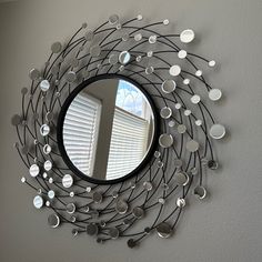 a circular mirror mounted to the side of a wall