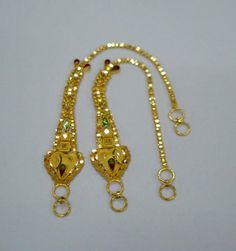 20kt gold ear chain pair from rajasthan india. great handmade design made of 20kt yellow gold adorn with meena colours. nice piece good for jewellery collection.Note - This chain can be wear with any earrings.Length max.- 12.8 cm(5")Width max.- 13.6 mmWeight - 6.860 gramsMaterial - 20kt yellow gold. Yellow Gold Meenakari Jewelry For Puja, Kan Chain Gold, 22k Gold Meenakari Jewelry For Puja, 22k Gold Tilla Jewelry For Puja, Yellow Gold Kundan Jewelry For Puja, Gold Danglers For Puja And Festive Occasions, Festive 22k Gold Yellow Jewelry, Yellow Temple Jewelry For Puja, Gold Jewelry With Meenakari For Puja