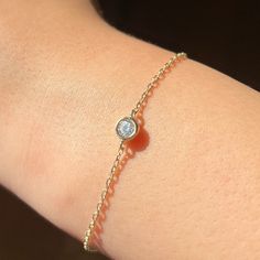 14k Solid Gold Dainty Chain Bracelet, Real Gold Bezel Bracelet, Premium Moissanite Bracelet For Her with premium grade D Color (colorless) VS/SI clarity moissanite.  Our chain is a special diamond cut chain with 1.35 mm thickness. It's dainty and sturdy. The moissanite is 0.25 ct. We're offering the finest quality in solid gold jewelry.  💙 Our jewelry is handcrafted with love and great care at San Francisco Bay! All of our items are 14k stamped for authenticity. 💙 You will receive them exactly as pictured. We don't use any filters, all photos are authentic and unedited. 💙 The material is 14k solid gold and should not be confused with gold plating or filling. It won't tarnish or fade over time. 💙 Quick shipping - Your order will be handcrafted and shipped in a few days. 💙 For the highe Silver 14k Gold Bracelet With Single Diamond, Diamond Bracelet With Birthstone For Anniversary, Anniversary Diamond Bracelet With Birthstone, 14k Gold Bracelets For Gift, 14k Gold Round Cut Bracelets For Gift, 14k Gold Bracelets For Gifts, 14k Gold Diamond Bracelet With Birthstone, 14k Gold Bracelet With Bezel Setting As Gift, White Gold Bracelet With Bezel Setting As Gift