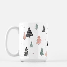 a white coffee mug with trees on it