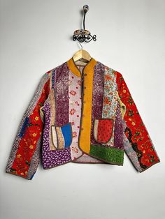 a colorful jacket hanging on a white wall