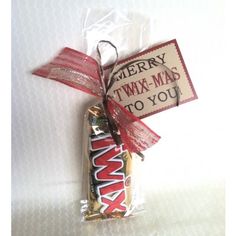 a candy bar wrapped in red and white paper with a tag that says merry twx - mad to you