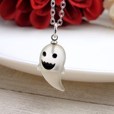 "This Ghost Charm necklace comes on a silver-plated chain that is available in different lengths. Please choose your desired length from the drop-down menu when placing the item in your shopping cart. { CHARM DETAILS } ★ Material: Resin ★ Finish Color: White ★ Measurements: 3/8\" x 3/4\" ★ Dimensions: 3-Dimensional { SIMILAR ITEMS } More Halloween themed items available from my shop: https://www.etsy.com/shop/treasuredcharms/search?search_query=halloween { GIFT OPTIONS} Gift boxes are available at no additional cost and can be added from the drop-down menu during checkout.   You can mark it as a gift, add a gift message, and send it directly to a recipient by entering their address in the 'shipping address' during checkout.  Receipts with price information are not included with orders that White Jewelry Gift, White Necklace For Halloween Gift, White Halloween Necklace Gift, Themed Personalized Jewelry For Halloween, White Gothic Necklace Gift, Personalized Themed Jewelry For Halloween, Fun White Halloween Jewelry, Halloween Themed Personalized Jewelry, Spooky White Halloween Jewelry