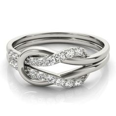 a white gold ring with diamonds in the center and an intertwined design on top