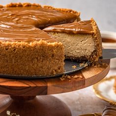 a chocolate cheesecake on a wooden cake stand