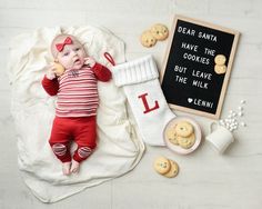 a baby laying on a blanket next to cookies