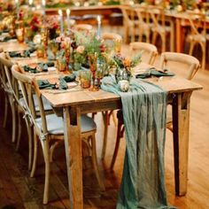 the table is set with green linens and candles