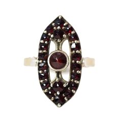 "Encrusted with 21 rose-cut garnets, this marvelous ring from the 1960s is Edwardian in style and set in gold over 900 silver. Made in Czechoslovakia, each garnet is prong-set in a pavé arrangement for maximum sparkle in the sunlight. Each garnet glows while the ring accents and elongates your fingers. An excellent piece for all seasons and occasions! Bohemian garnets came from the hills of Bohemia in Czechoslovakia and were very popular from the 1820s to 1920s with the European upper class. To Vintage Red Garnet Cluster Ring, Vintage Garnet Cluster Ring As Gift, Vintage Multi-stone Ruby Cluster Ring, Vintage Ruby Multi-stone Cluster Ring, Vintage Garnet Cluster Ring With Gemstone, Vintage Ruby Cluster Ring With Multi-stones, Vintage Multi-stone Ruby Ring Collectible, Vintage Multi-stone Ruby Ring, Vintage Ruby Cluster Ring Hallmarked