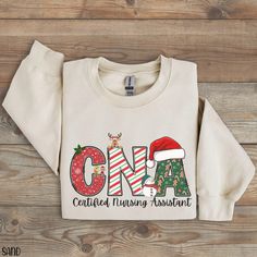 CNA Sweatshirt for CNA Christmas Shirt, Certified Nursing Assistant Christmas Sweater, Christmas Cna Crewneck, CNA Shirt for Christmas Tee If you are looking for soft, well designed, and comfy t -shirts and Sweatshirts, you have come to the right place! We hand design all of the shirts in this shop and strive to provide beautiful shirts/Sweatshirts for all occasions. If you have any questions about our items, please feel free to shoot us a message anytime. We try our best to message everyone back within 24 hours. Product Details: Ideal for any situation, a unisex heavy blend crewneck sweatshirt is pure comfort. These garments are made from polyester and cotton. This combination helps designs come out looking fresh and beautiful. The collar is ribbed knit, so it retains its shape even after Cna Christmas Shirts, Cna Shirt Ideas Vinyl, Cna Shirts Ideas, Cna Shirts, Western Sweatshirts, Certified Nursing Assistant, Hand Design, Nursing Assistant, Sweater Christmas