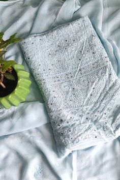 a potted plant sitting on top of a white blanket