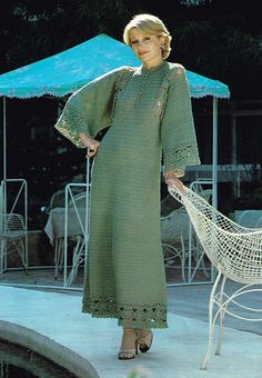 a woman standing next to a white chair